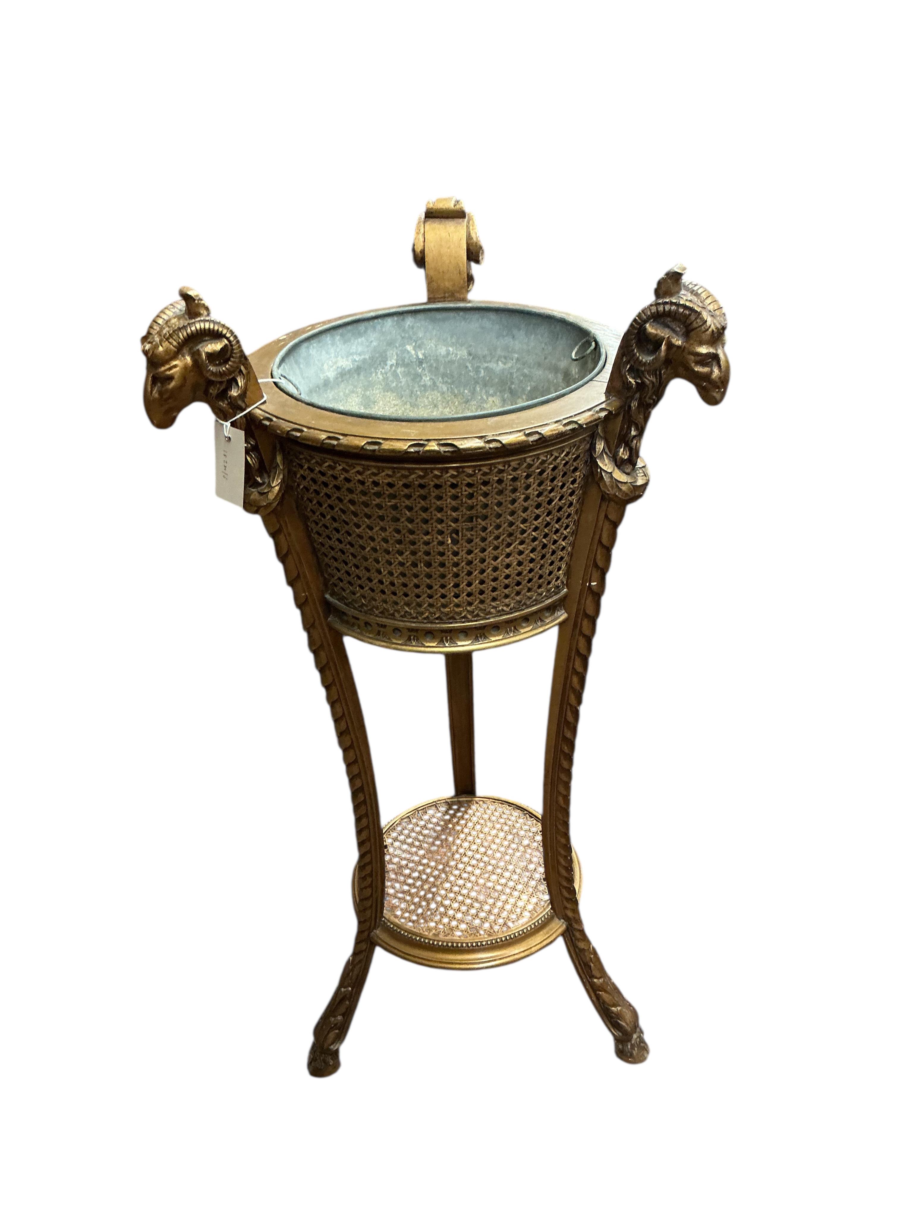 A Victorian style caned giltwood jardiniere with ram's head finials, height 99cm